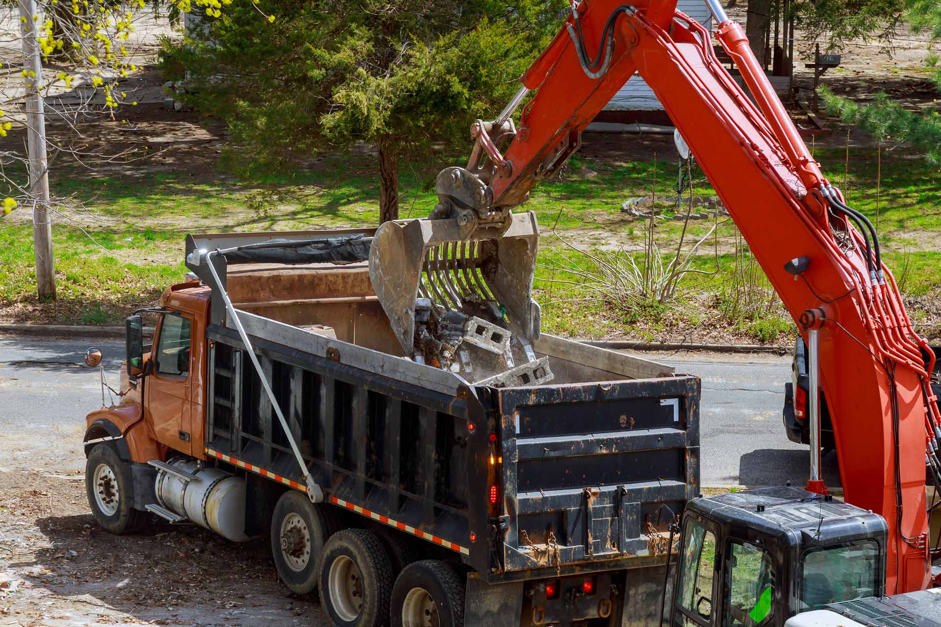 excavator-picks-up-construction-waste-for-loading-CVPJ63X.jpg